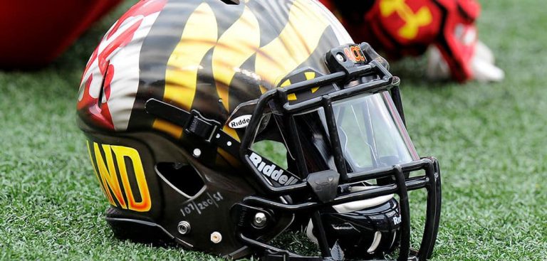 Maryland football helmet resting on turf