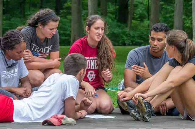 athletes in group small circle talking