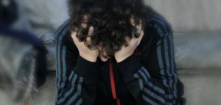 young athlete with hands over face