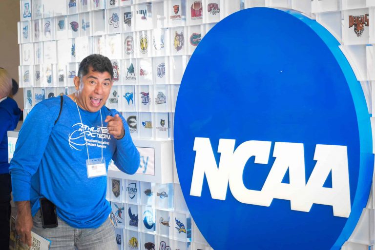 Coach standing in front of an NCAA sign