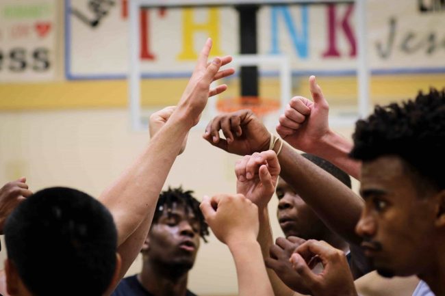 A team huddled with hands together