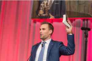 Kirk Cousins holding his Bible and giving his testimony