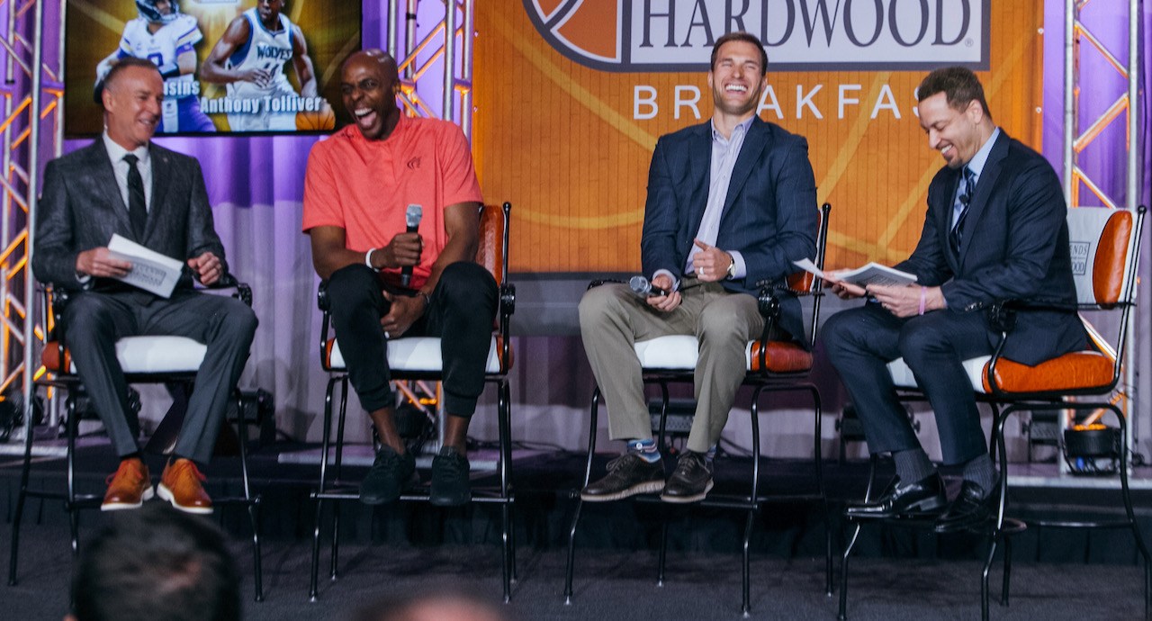 Speakers on stage at an AIA basketball breakfast