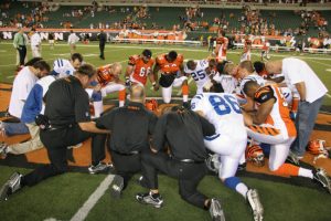 NFL players praying on field