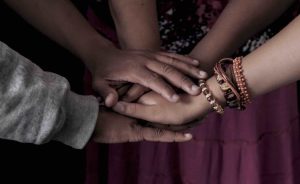A group put their hands together in support of one another