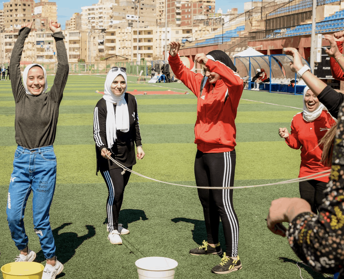 AIA softball players with women athletes in North Africa
