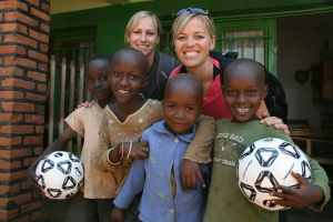 Two adults and four kids smiling