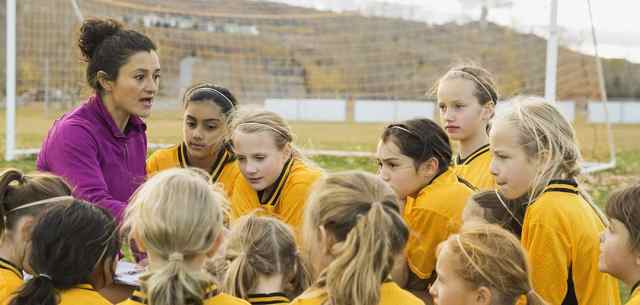 coach with girls soccer team