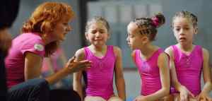 woman comforting young gymnast