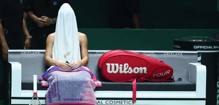 athlete with towel over head