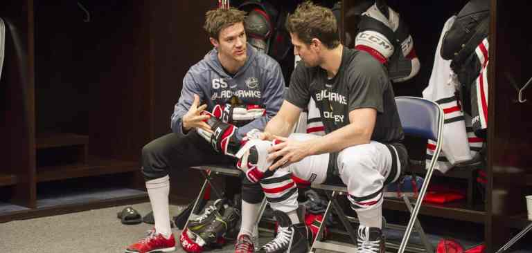 UR_leadership_in_locker_room hockey athletes talking to each other in locker room
