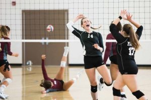 Volleyball players high fiving after a play