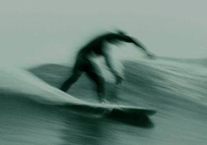 blurred picture of a surfer tinted green