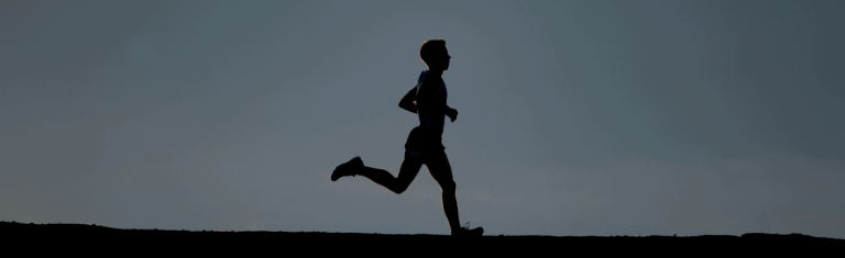 black and white silhouette of a man running