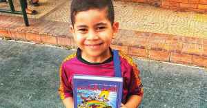 refugee child with children's Bible