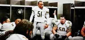 american football players having a pre game talk