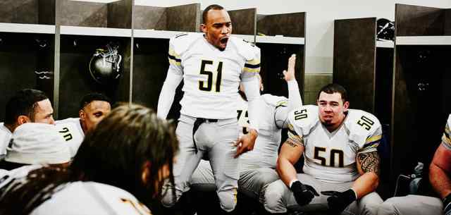 american football players having a pre game talk