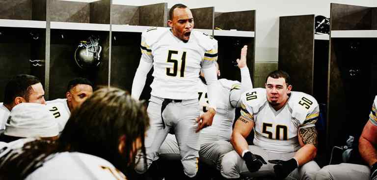 american football players having a pre game talk