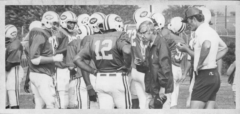 black and white picture of coach with American football team