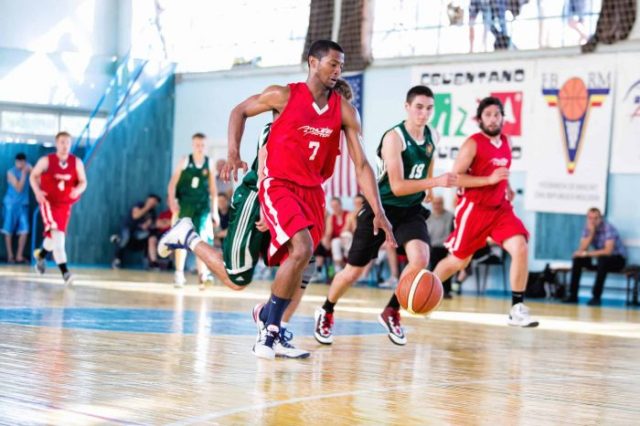 Athlete dribbling basketball during game