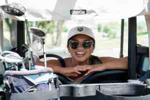 Smiling female in golf cart