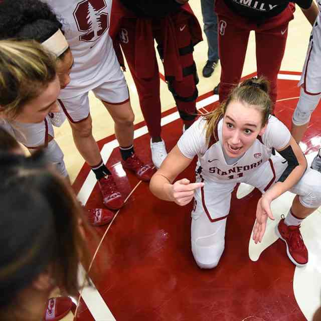 college female athletes in huddle