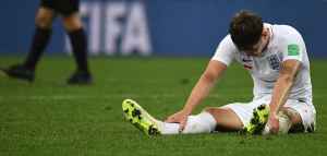 soccer player sitting on the field with his head down