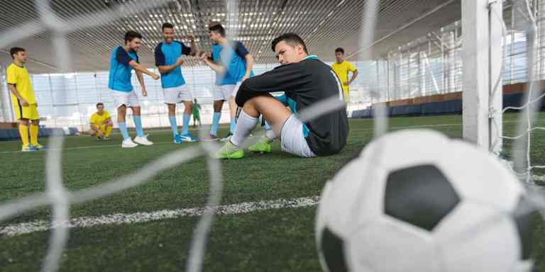 Young soccer goalie sitting