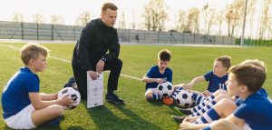 coach leading boys's soccer