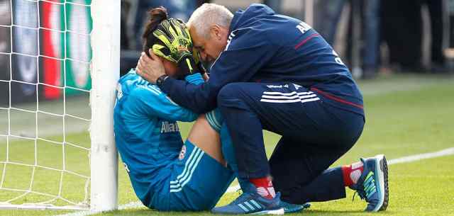 coach comforting athlete