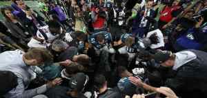 Philadelphia Eagles in a prayer huddle