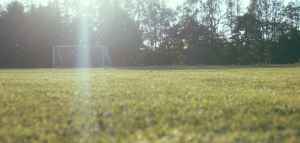 empty soccer field with goal net in the distance