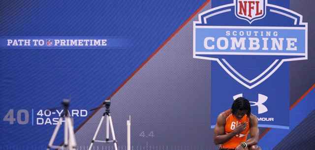 athlete standing in front of NFL combine sign
