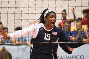 Female volleyball athlete at the net