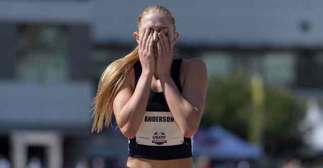 female runner with hands pressed over her face