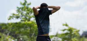 athletic man with shirt pulled over his face