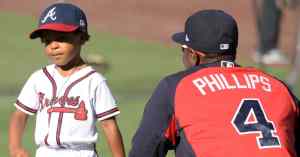 young baseball player with older player