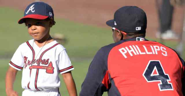young baseball player with older player
