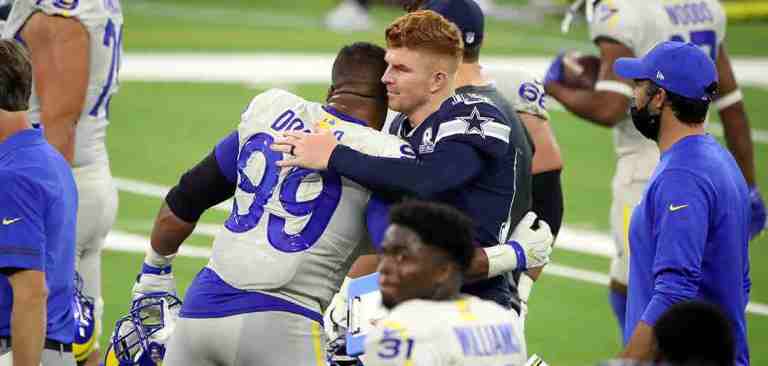 profile_andy_dalton Andy Dalton hugging a professional football player from an opposing team