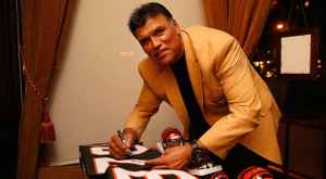 Anthony Munoz signing a Cincinnati Bengals jersey