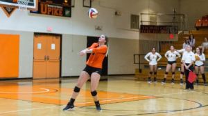 female volleyball player serving the ball