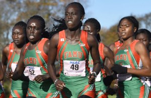 Several women from the same team in a race, running toward the camera