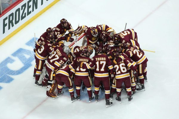 U. of Minnesota-Duluth hockey team in a huddle on the ice