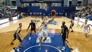 basketball player going up to make a basket