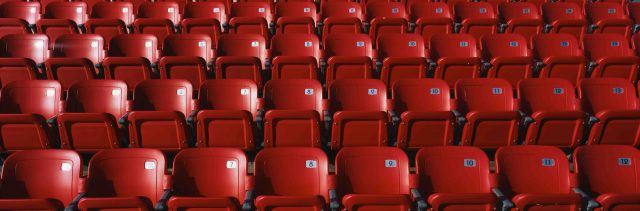 empty red stadium chairs
