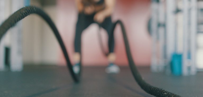 Athlete exercising with heavy ropes