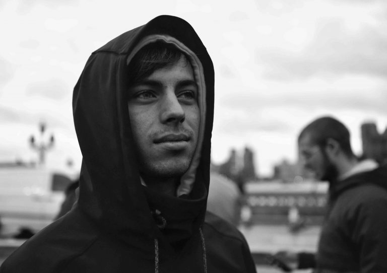 black and white picture of a man wearing sweatshirt with hood drawn