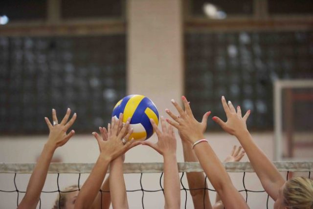 female athletes playing volleyball