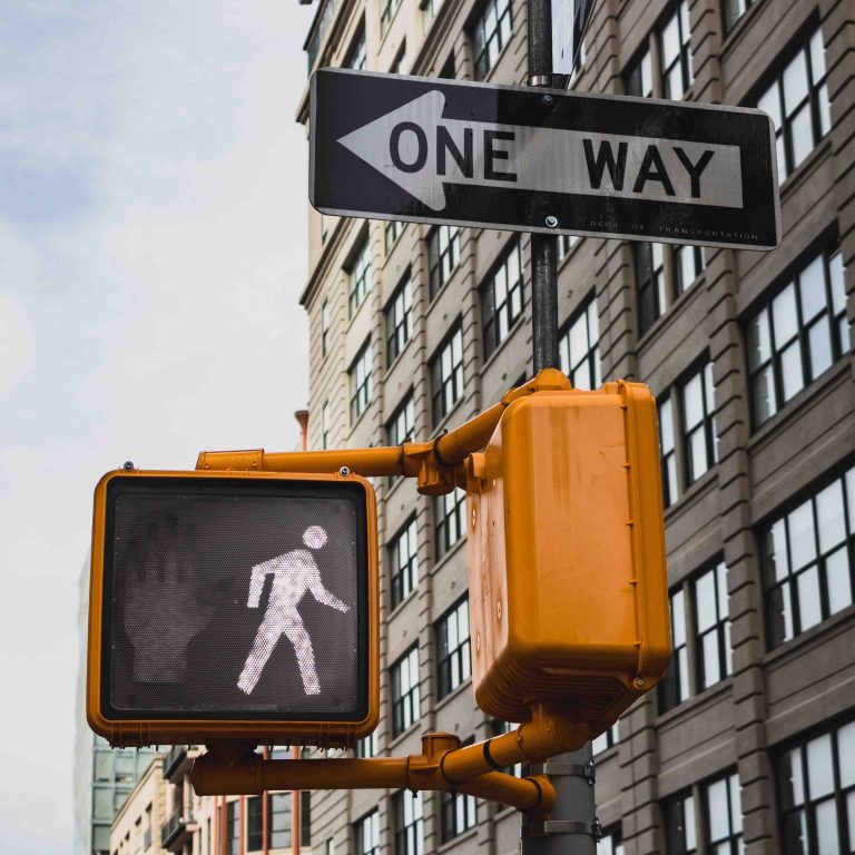 one way sign and pedestrian crossing sign