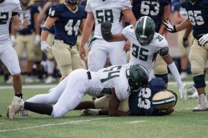 high school american football players tackling